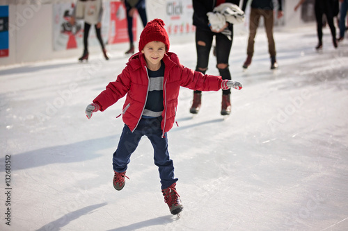 Happy boy with red hat, skating during the day, having fun