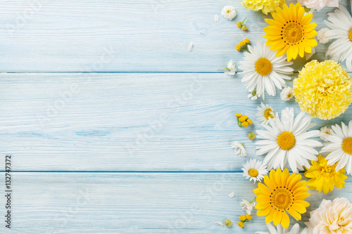 Garden flowers over wooden background