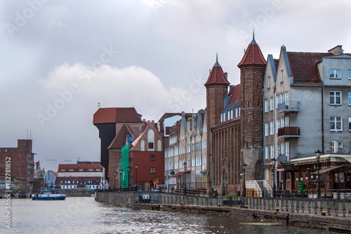 Panorama of historic part of town and the Motlawa River with its famous medieval Crane and Gate Straganiarska. Gdansk is a Polish city on the Baltic coast and popular center of tourism.