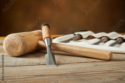 woodworking tolls, chisels and mallet on workbench