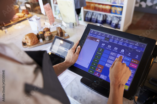 Close Up Of Female Employee Working At Delicatessen Checkout