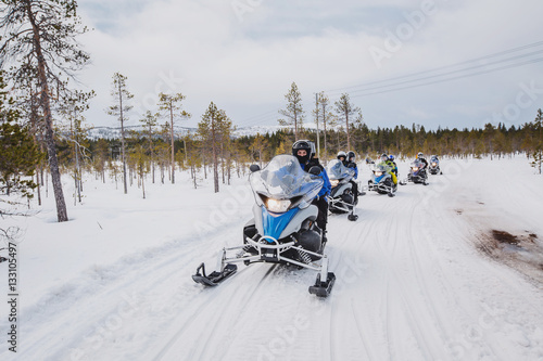 man driving snowmobile in Finnish Lapland