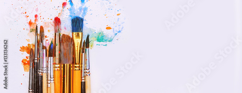 artistic brushes on wooden background