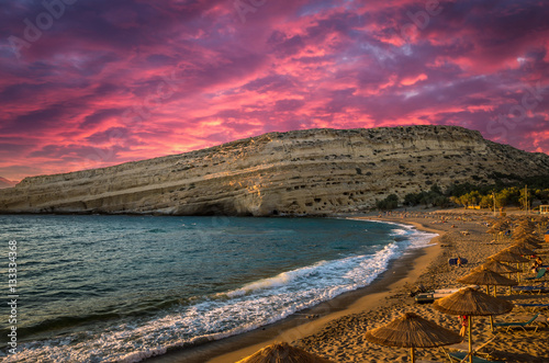 Matala beach on Crete island, Greece. Stunning sunset over the beach.