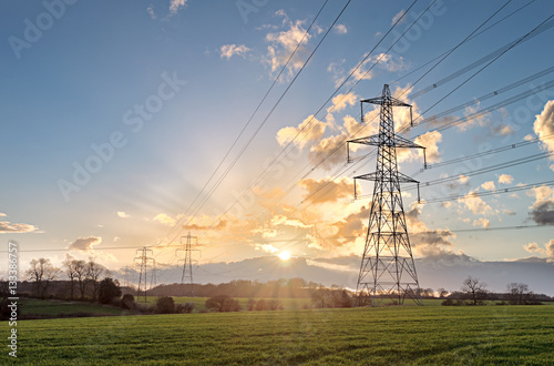 Electricity Pylon - UK standard overhead power line transmission tower at sunset.