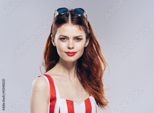 womanwoman, striped cloth, red and white dress, glasses, gray background in a red and white dress, emotions