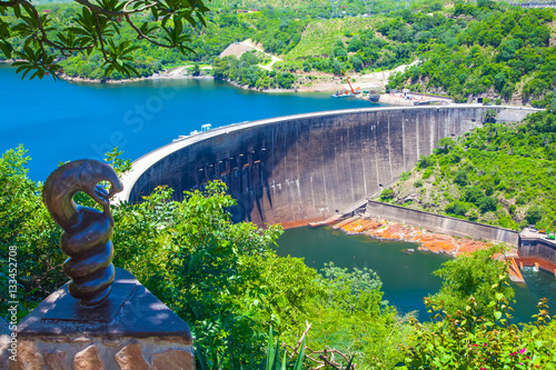 Lake Kariba dam wall and a statue of nyami nyami the river snake god. Zambezi river. Zimbabwe Africa.