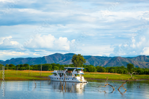 Lake Kariba Dam Reflections On the Water. House Boat and Clouds.