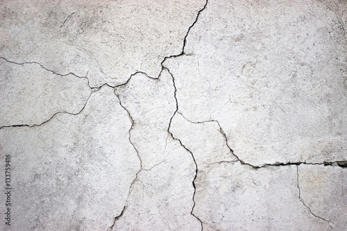 cracked concrete wall covered with gray cement texture as backgr
