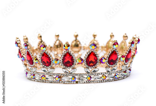 Gold crown of queen with red and white jewel of precious stones.