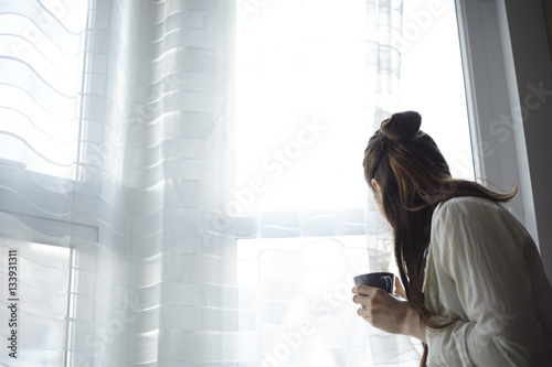 Woman at home waiting with coffee