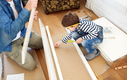 Father and son assembling furniture