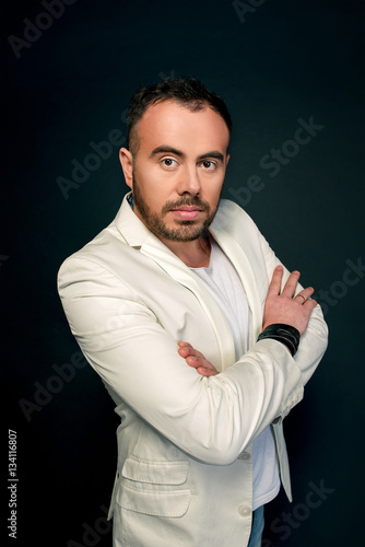 Portrait of man in white suits on dark background