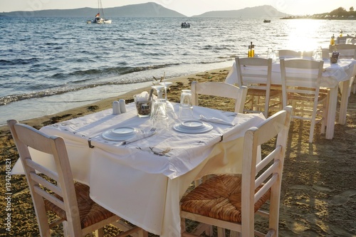 Table set on the beach at a traditional Greek taverna restaurant in Messenia, Greece