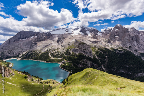 View of the Marmolada, also known as the Queen of the Dolomites and the Fedaia Lake. Marmolada is the highest mountain of the Dolomites, situated in northeast of Italy.