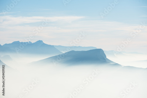 beautiful french alps winter panoramic aerial view landscape with a fantastic blue haze cloudy mountain background