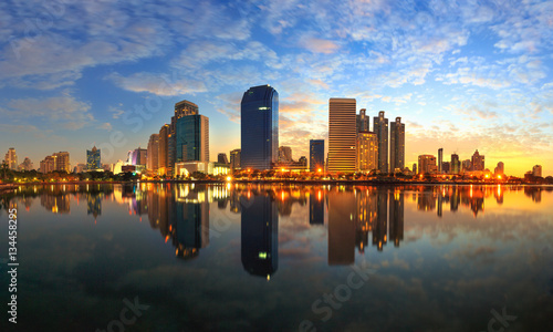 Business district cityscape from a park with sunrise time from B