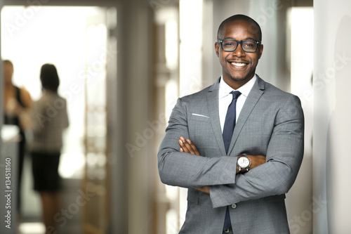 Handsome cheerful african american executive business man at the workspace office 