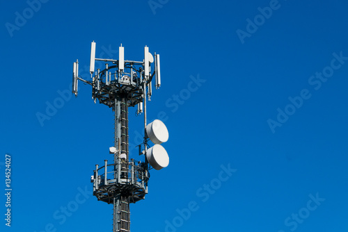 Communication tower against crystal clear blue sky background