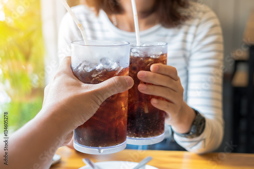 Men and Woman hand giving glass of cola.Glass of cola ,Soft drink