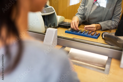 clerk counting cash money at bank office