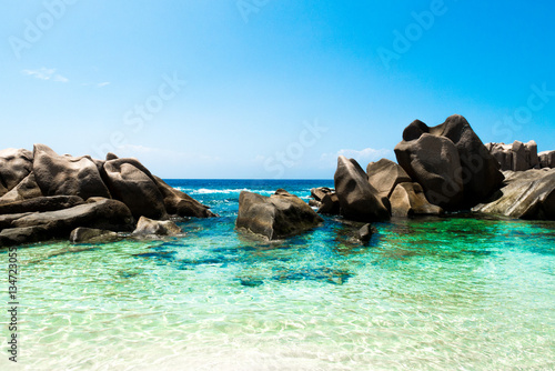 Natural pool of turquoise water on a tropical desert beach, Anse Marron, La digue, Seychelles