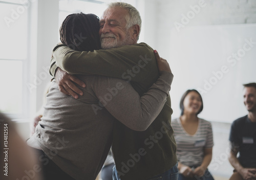 Old guy consoling a woman with a hug