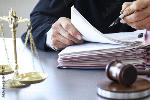 Scales of justice with judge gavel on table