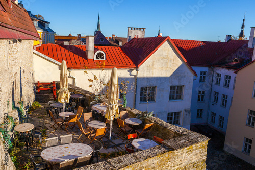 Cosy cafe on medieval wall of old town of Tallinn with beautiful cityscape with red roofs