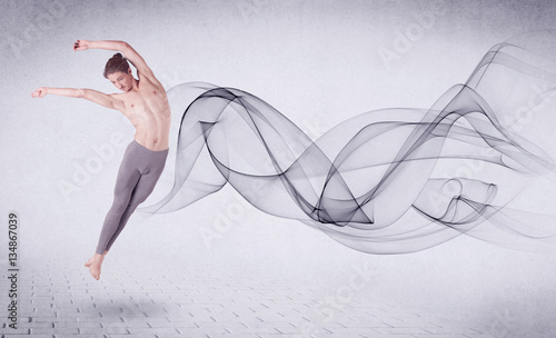 Modern ballet dancer performing with abstract swirl