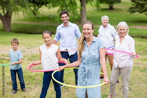 Multi-generation family playing with hula hoop