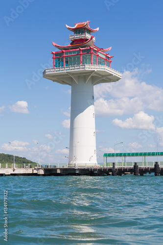 Asian lighthouse over the coastline with blue sky background