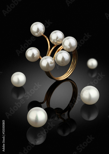 macro jewelry piece, ring with pearls on black background