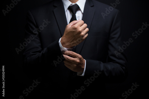 Businessman adjusting his cufflinks