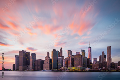 View of the New York Lower Manhattan buildings with colorful clouds above