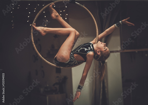 Plastic little girl gymnast on acrobatic ring