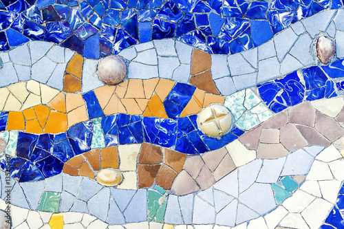 Closeup of mosaic of colored ceramic tile by Antoni Gaudi at his