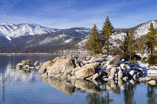 Winter shot of Lake Tahoe with snow on rocks and mountains. Sand Harbor, Nevada