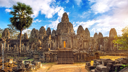 Ancient stone faces at sunset of Bayon temple, Angkor Wat, Siem reap, Cambodia.