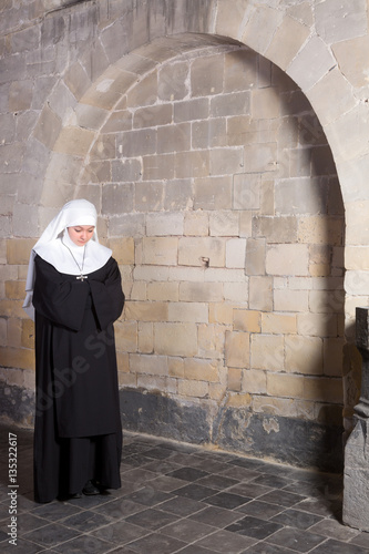 Young nun in old church