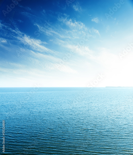 perfect sunset in blue sky over sea. aerial view