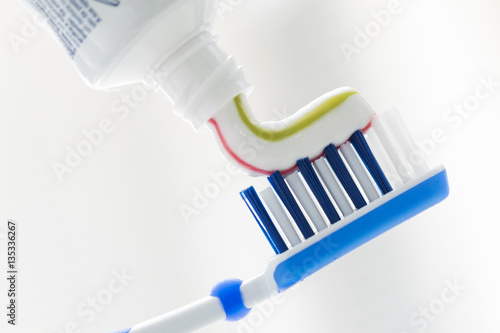 Toothbrush and toothpaste on blurred background with copy space