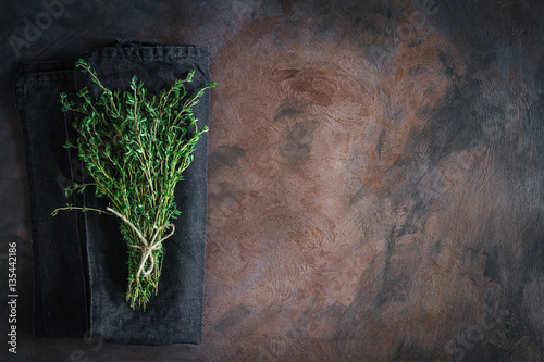 Thyme tied on a rusty background with copy space. Top view, flat lay