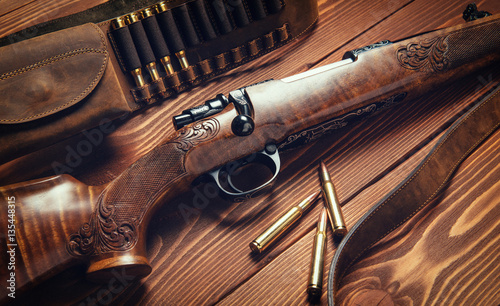 Hunting equipment on old wooden background