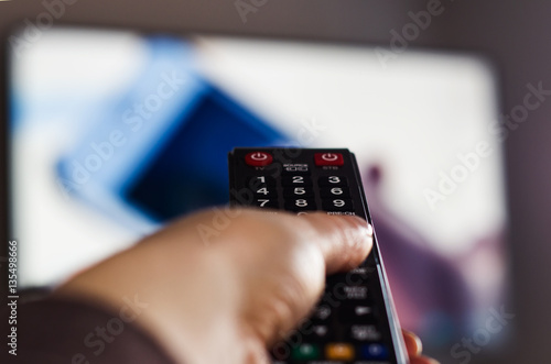 TV remote control, the hand with a remote control.