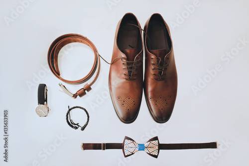 Men's shoes, tie, watches, belt on the light background