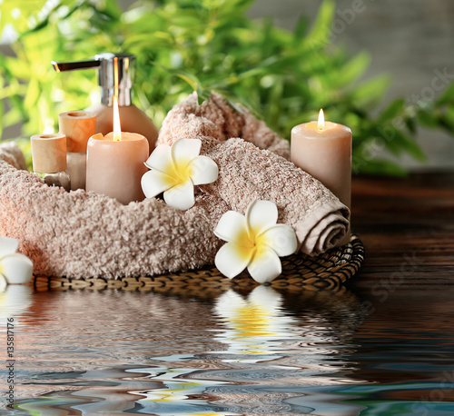 Beautiful spa composition with reflection on water surface