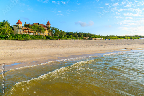 A view of Leba beach and historic hotel building on sand dune, Baltic Sea, Poland