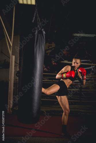 Girl in front of a training bag