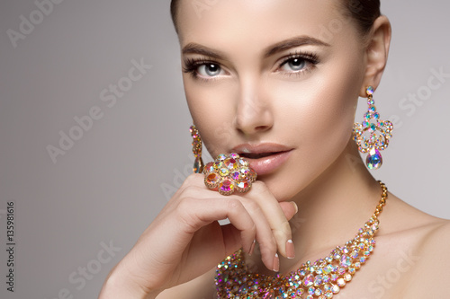 Beautiful woman in a necklace, earrings and ring. Model in jewel